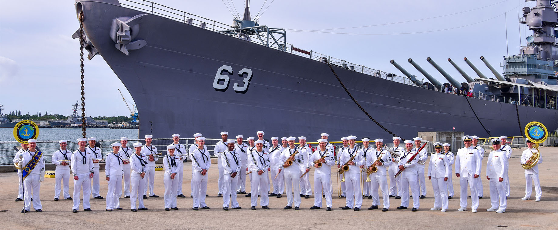 The U.S. Pacific Fleet Band wind ensemble poses in front of USS Missouri (BB 63).
